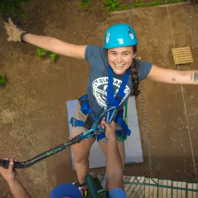 A woman looking up at the sky from a zipline
