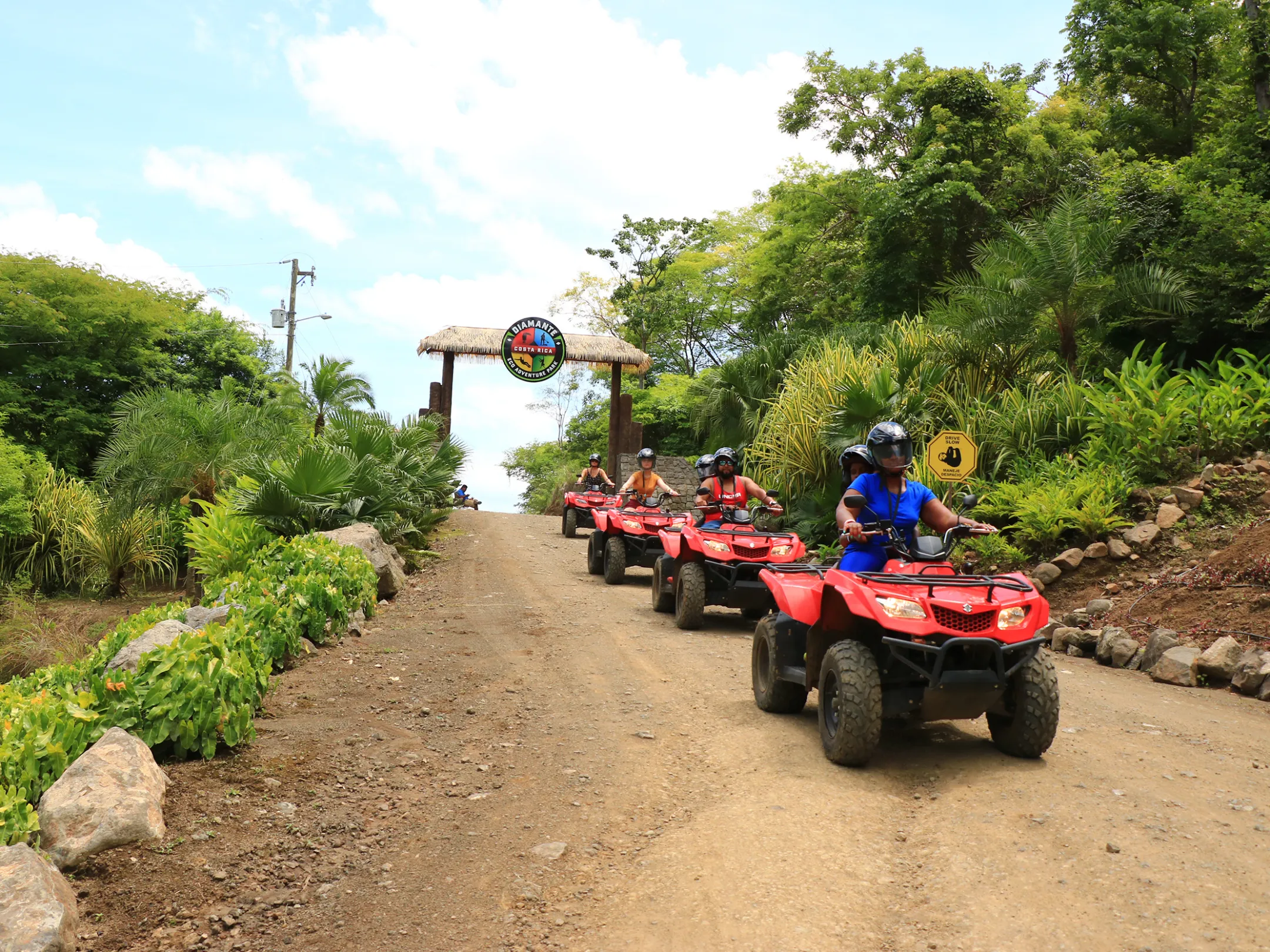 A group riding ATVs through the jungle