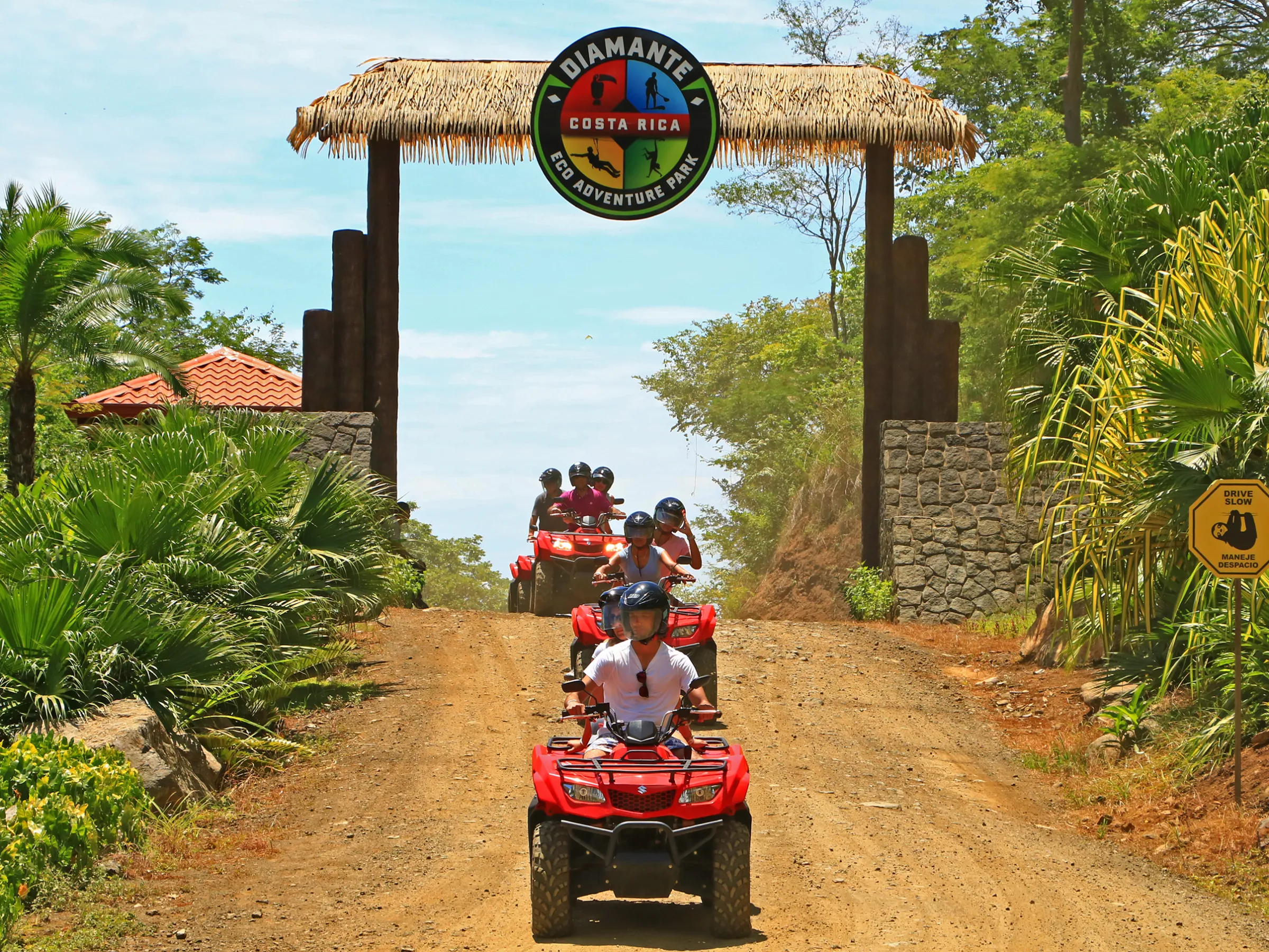 A group riding ATVs through the jungle