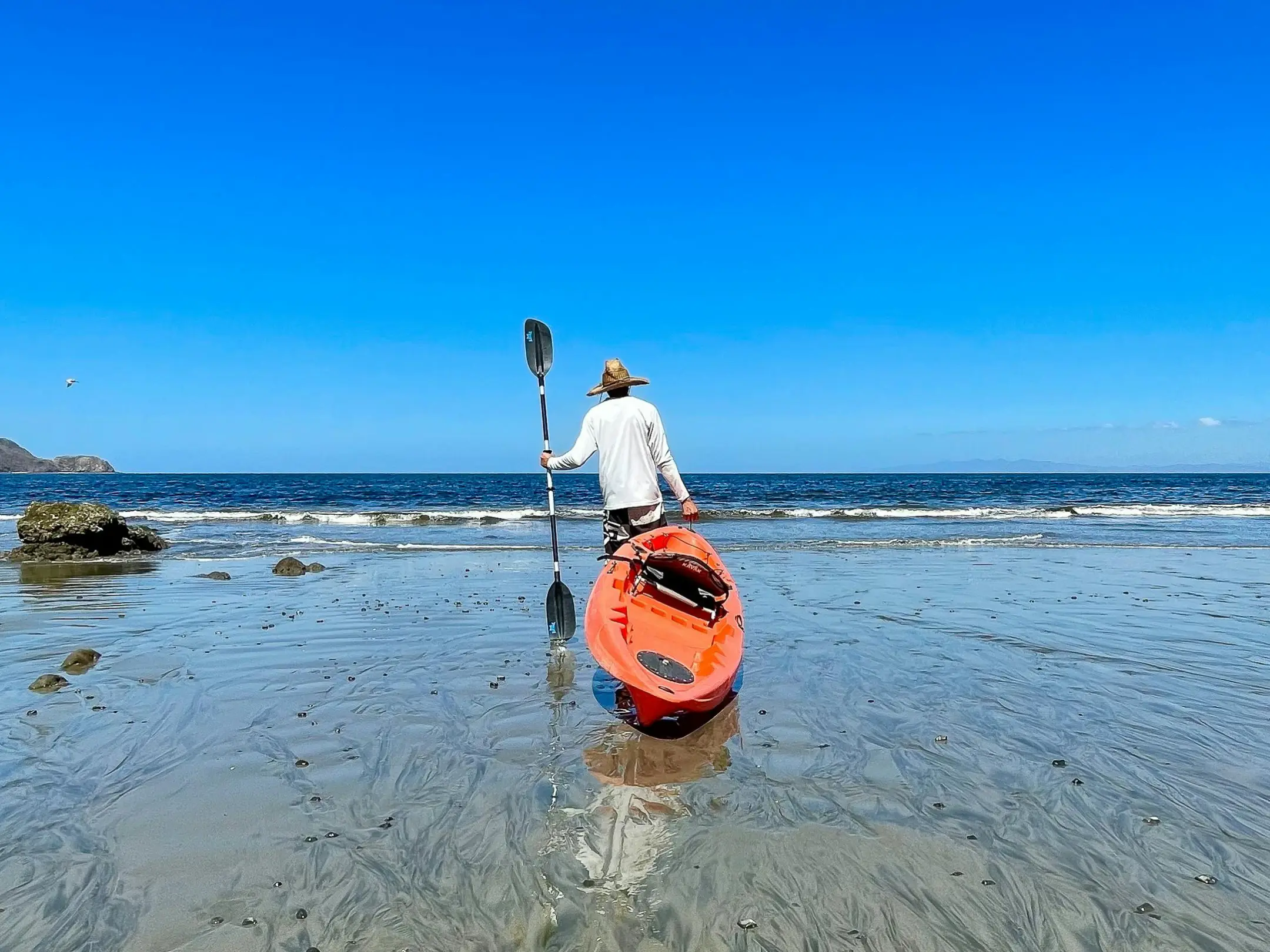 a person standing next to a body of water