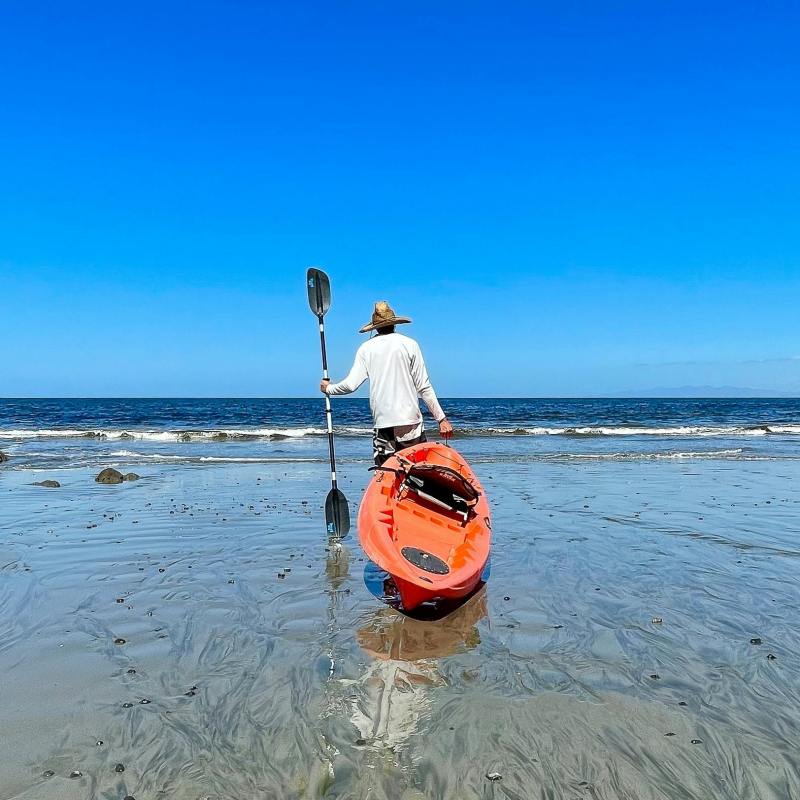 a person standing next to a body of water