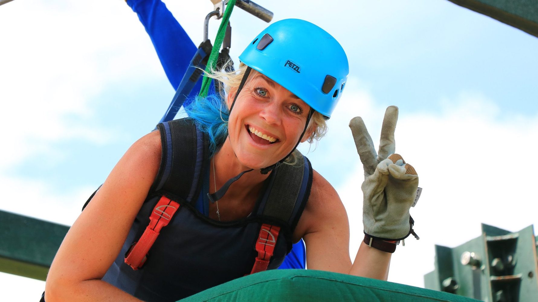 A woman getting ready for the superman zipline