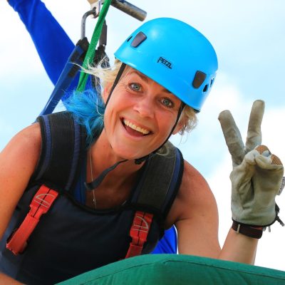 A woman getting ready for the superman zipline