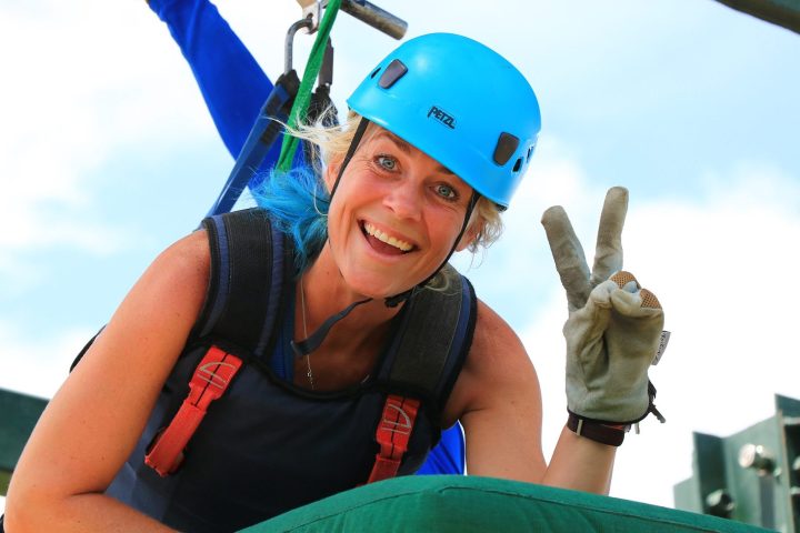 A woman getting ready for the superman zipline