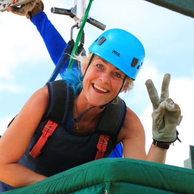 A woman getting ready for the superman zipline