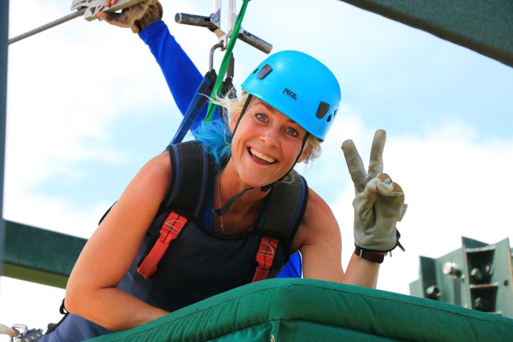 A woman getting ready for the superman zipline