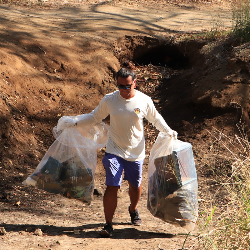 a man that is standing in the dirt