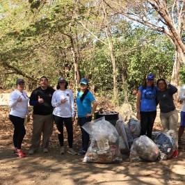 a group of people standing next to a tree