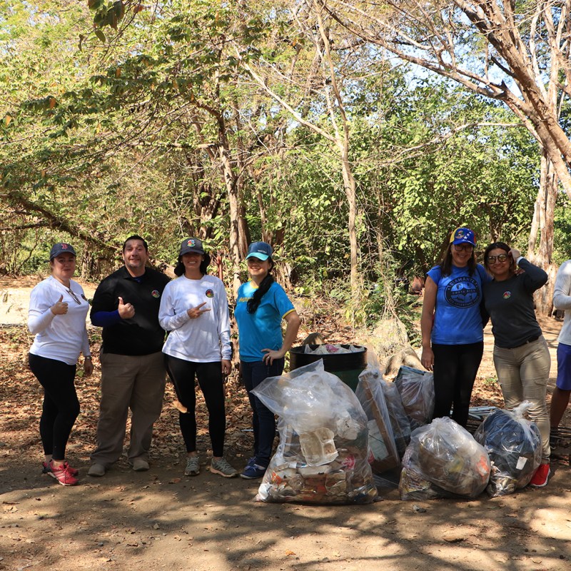 a group of people standing next to a tree
