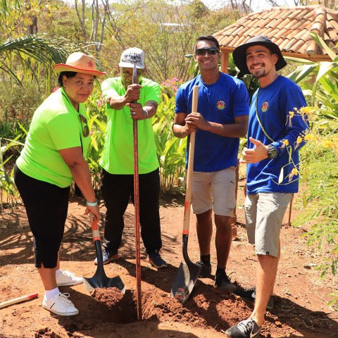 a group of people standing next to a tree