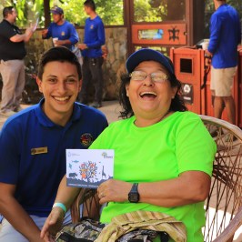 a group of people sitting on a bench posing for the camera