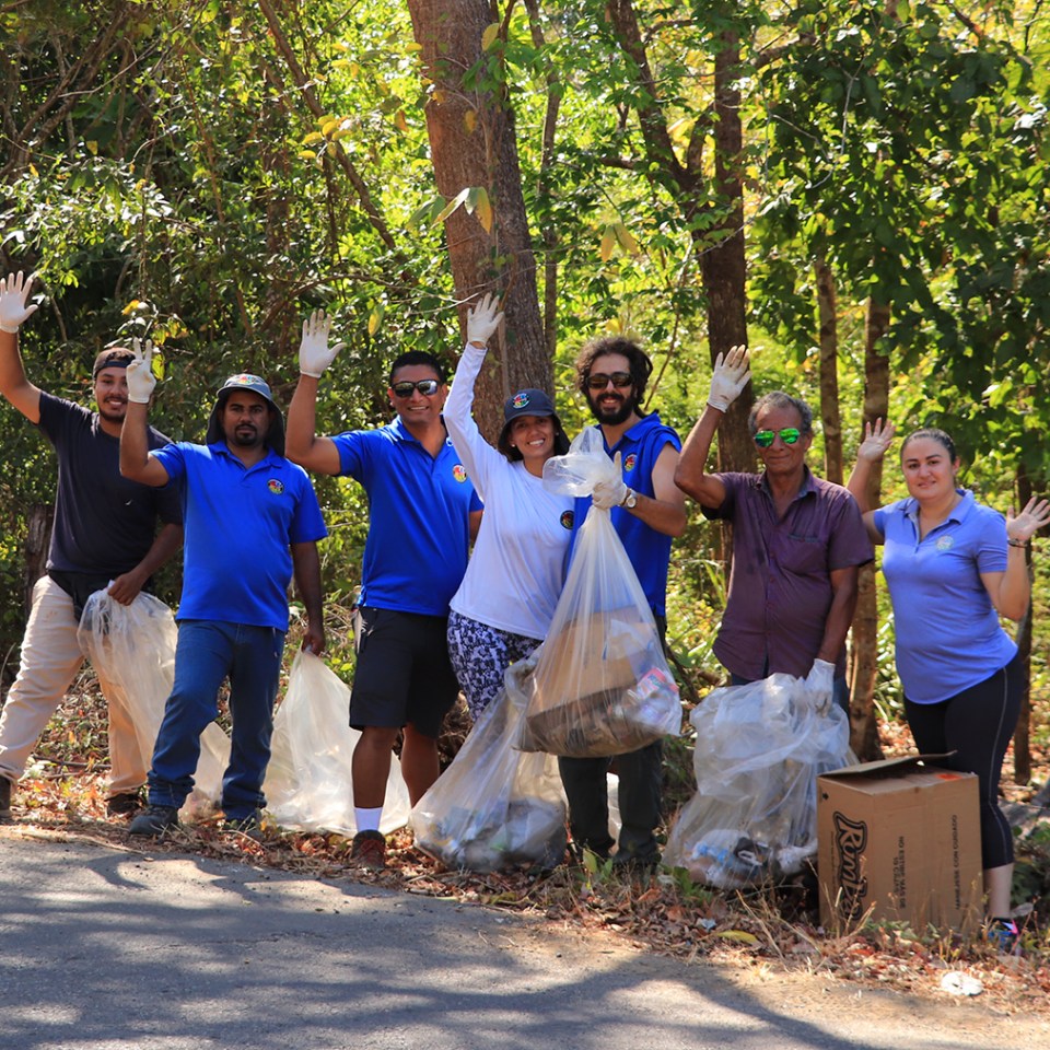 a group of people standing next to a tree