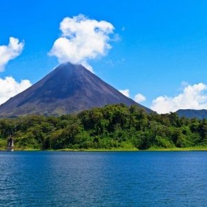a large body of water with a mountain in the background