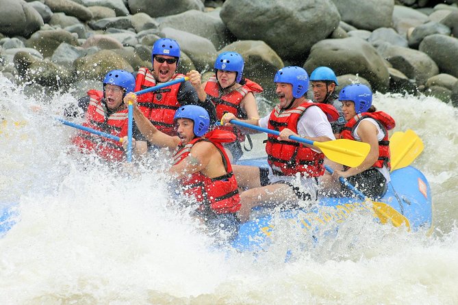 a group of people riding on a raft in a body of water