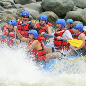 a group of people riding on a raft in a body of water