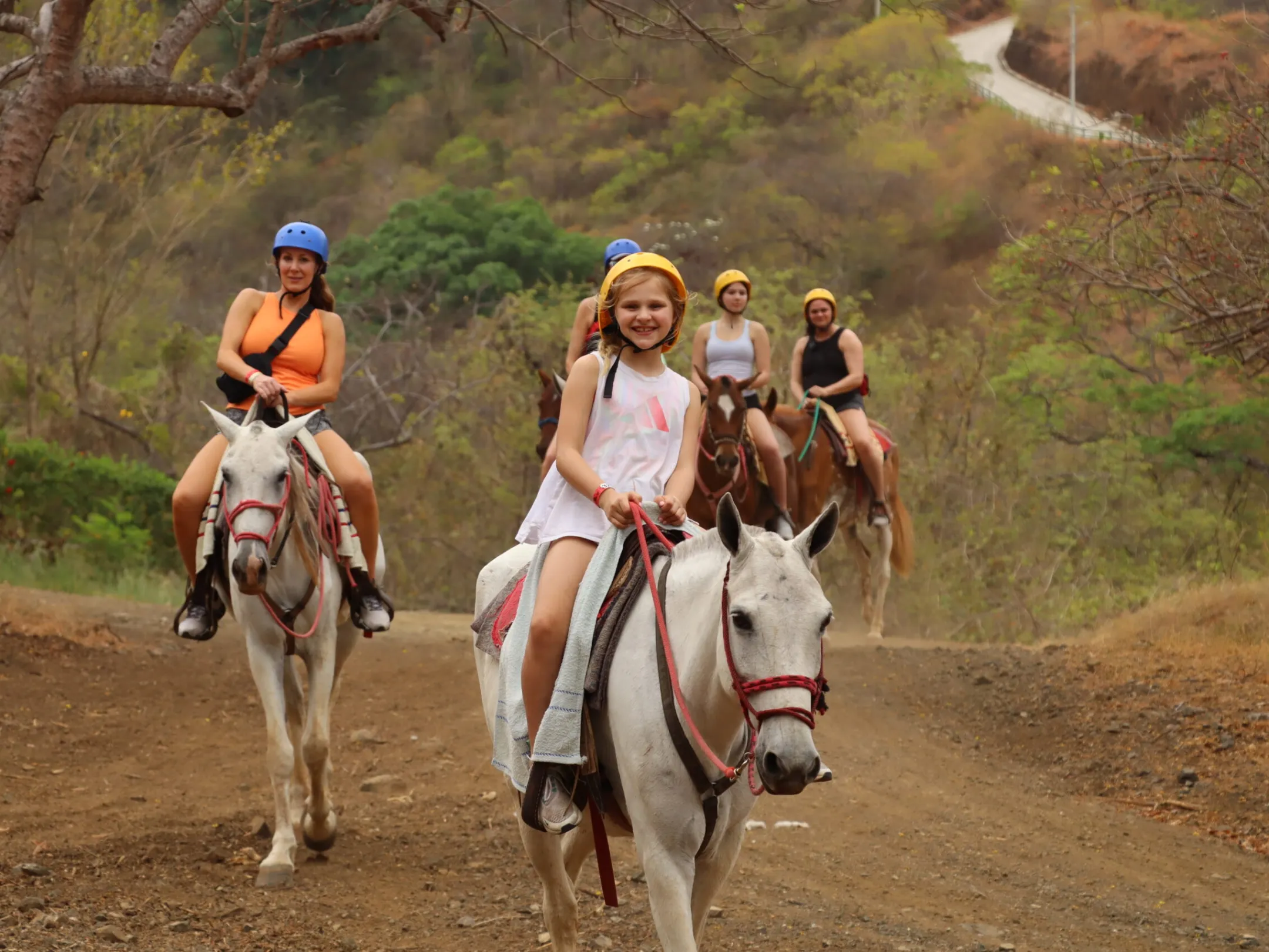 a man riding a horse on a dirt road
