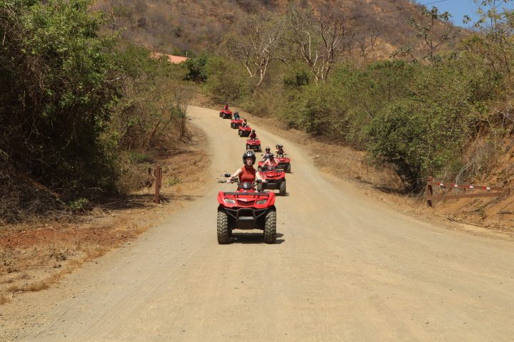 a person riding a motorcycle down a dirt road