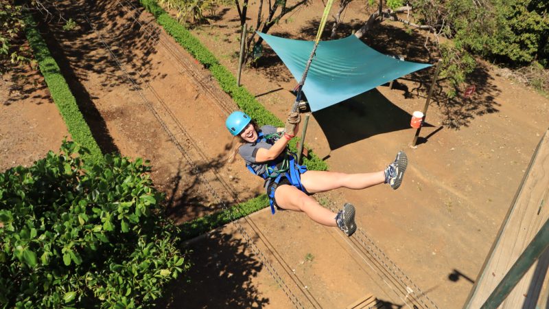 a man flying through the air while riding a bike down a dirt road