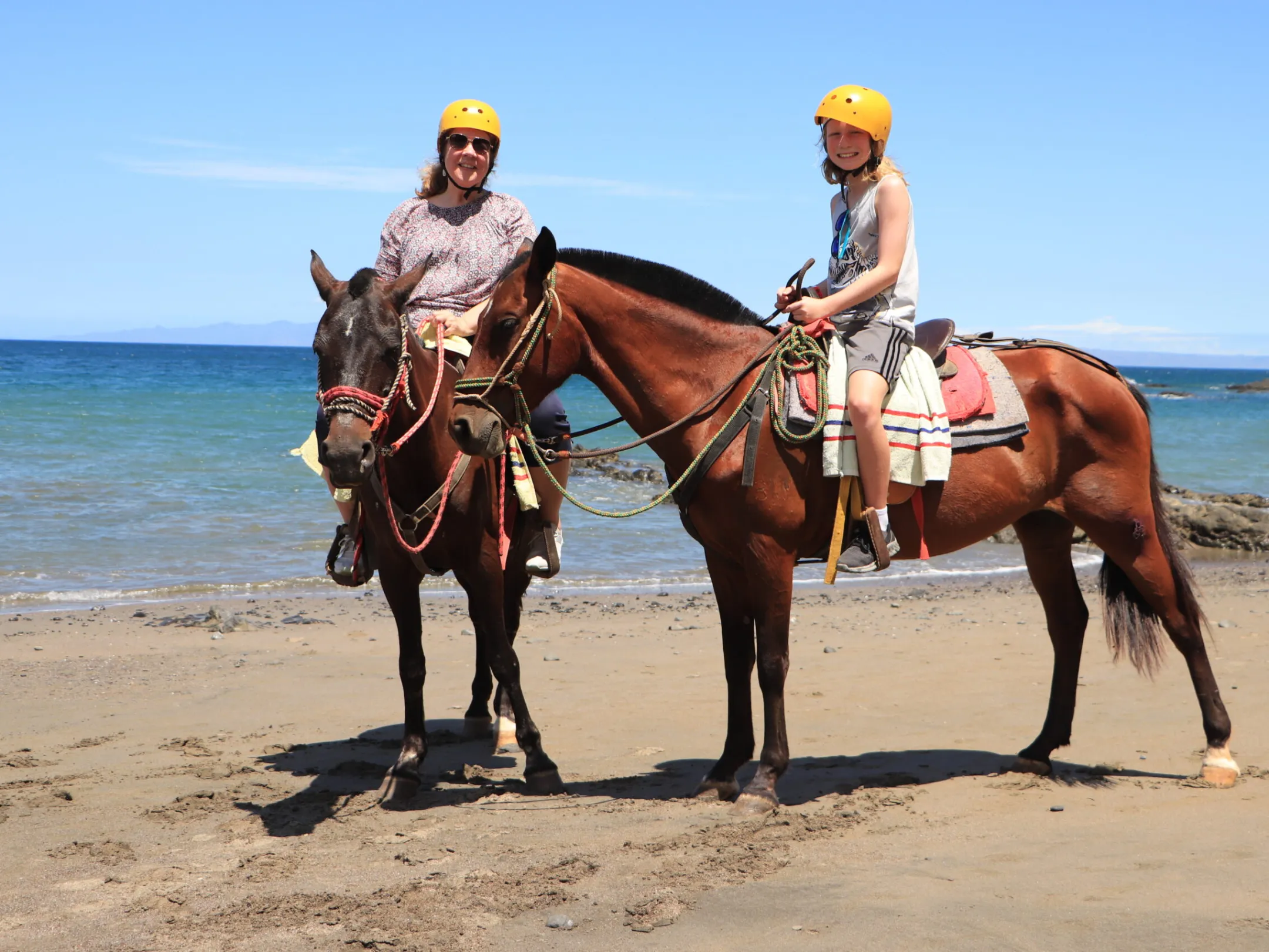 a person riding a horse on a beach