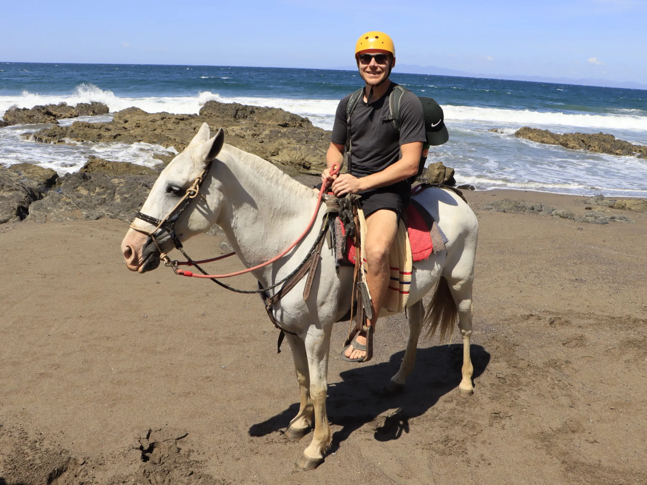 a man riding a horse on a beach
