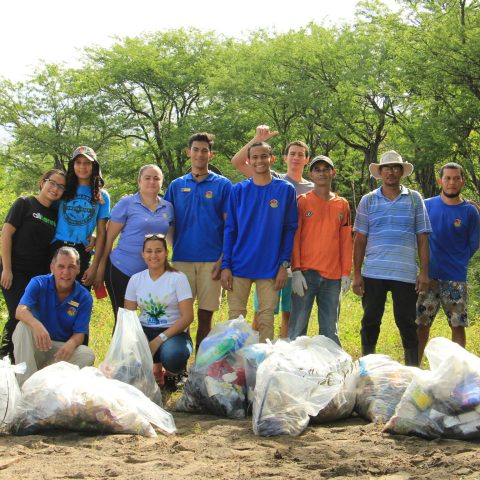 a group of people that are standing in the grass