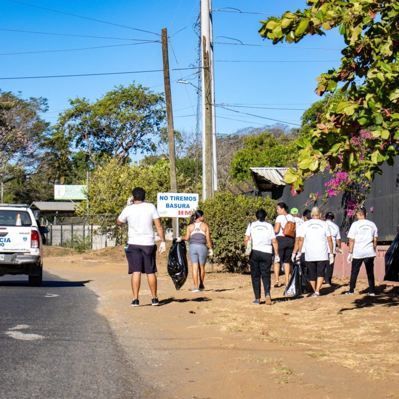 a group of people standing in a parking lot