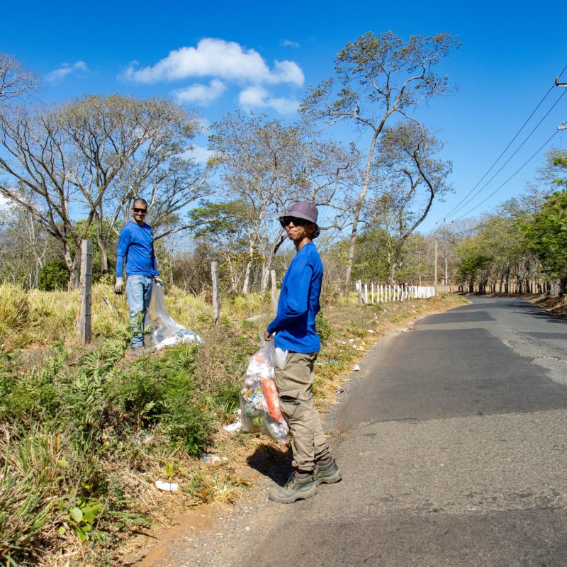 a young man riding a bike down a dirt road
