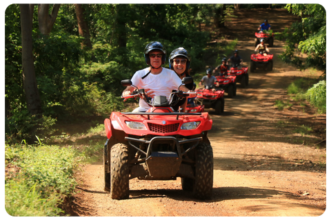 a man riding a motorcycle down a dirt road