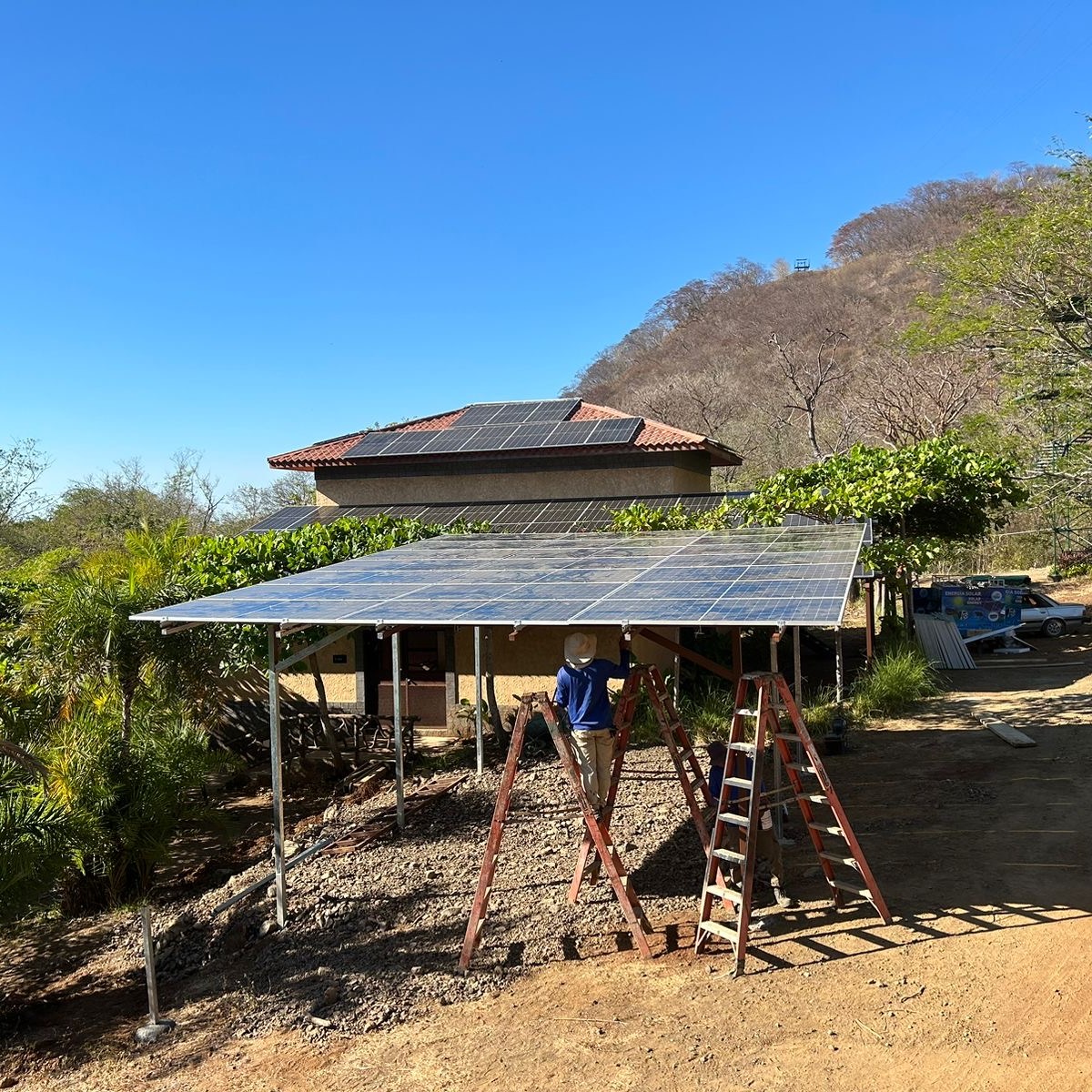 a group of people walking down a dirt road