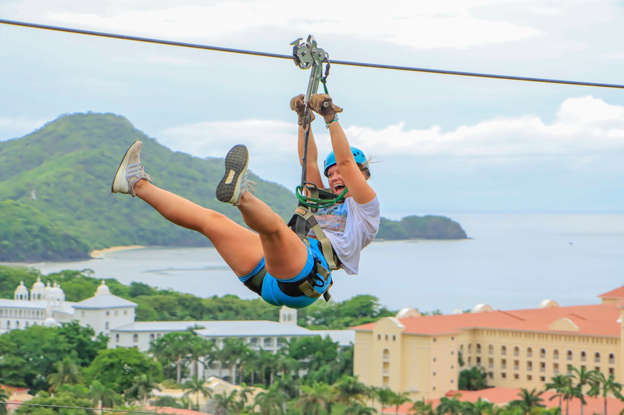 Guest flying Superman-style on the Diamante zip line above the Guanacaste coast
